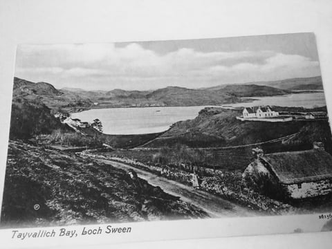 Black and white vintage photograph of Tayvallich Bay in Loch Sween, Scotland, showing a coastal landscape with hills, water, and a ship