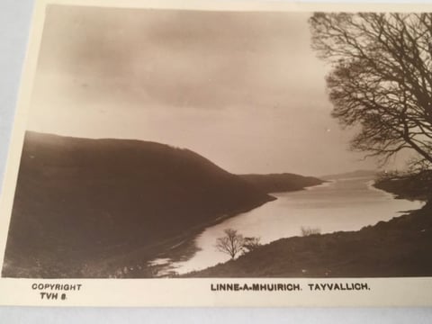 Sepia-toned vintage photograph of Linne-a-Mhuirich in Tayvallich, Scotland, showing a mountainous landscape with a lake surrounded by bare trees.
