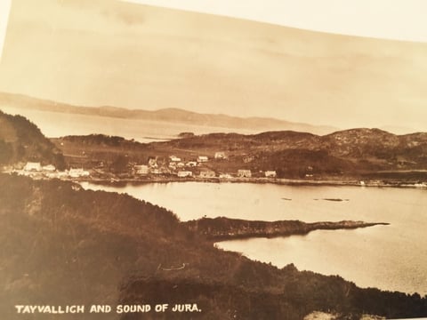 Sepia-toned historical photograph of Tayvallich village overlooking the Sound of Jura with forested hills and calm waters